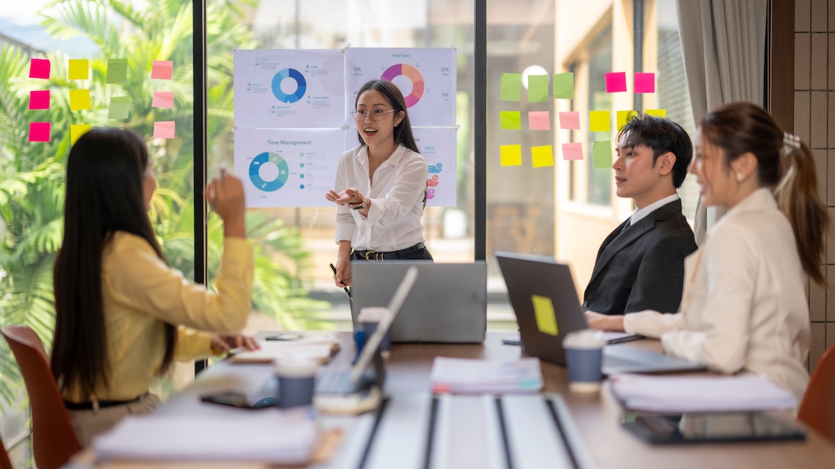 Business,Team,Collaborating,In,A,Modern,Office,,Using,Charts,And