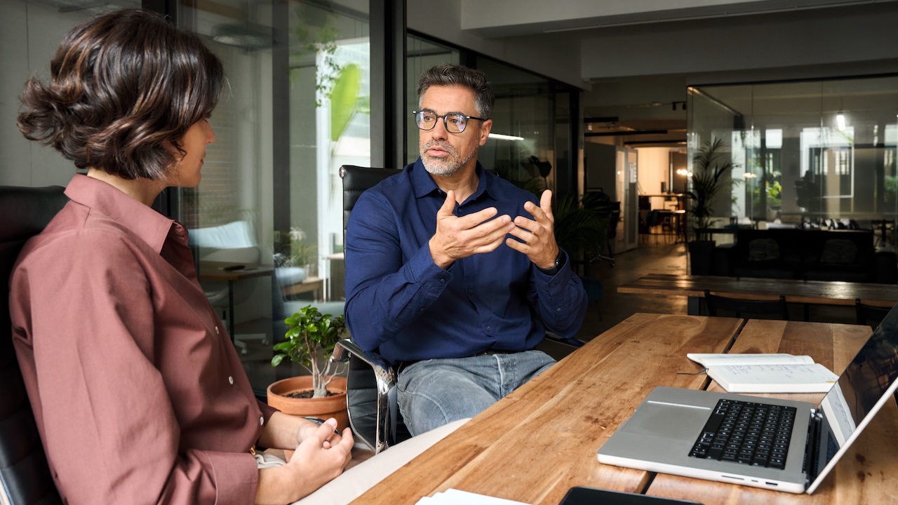 Business,Team,Of,Two,Busy,Professionals,Working,Together,Discussing,Corporate